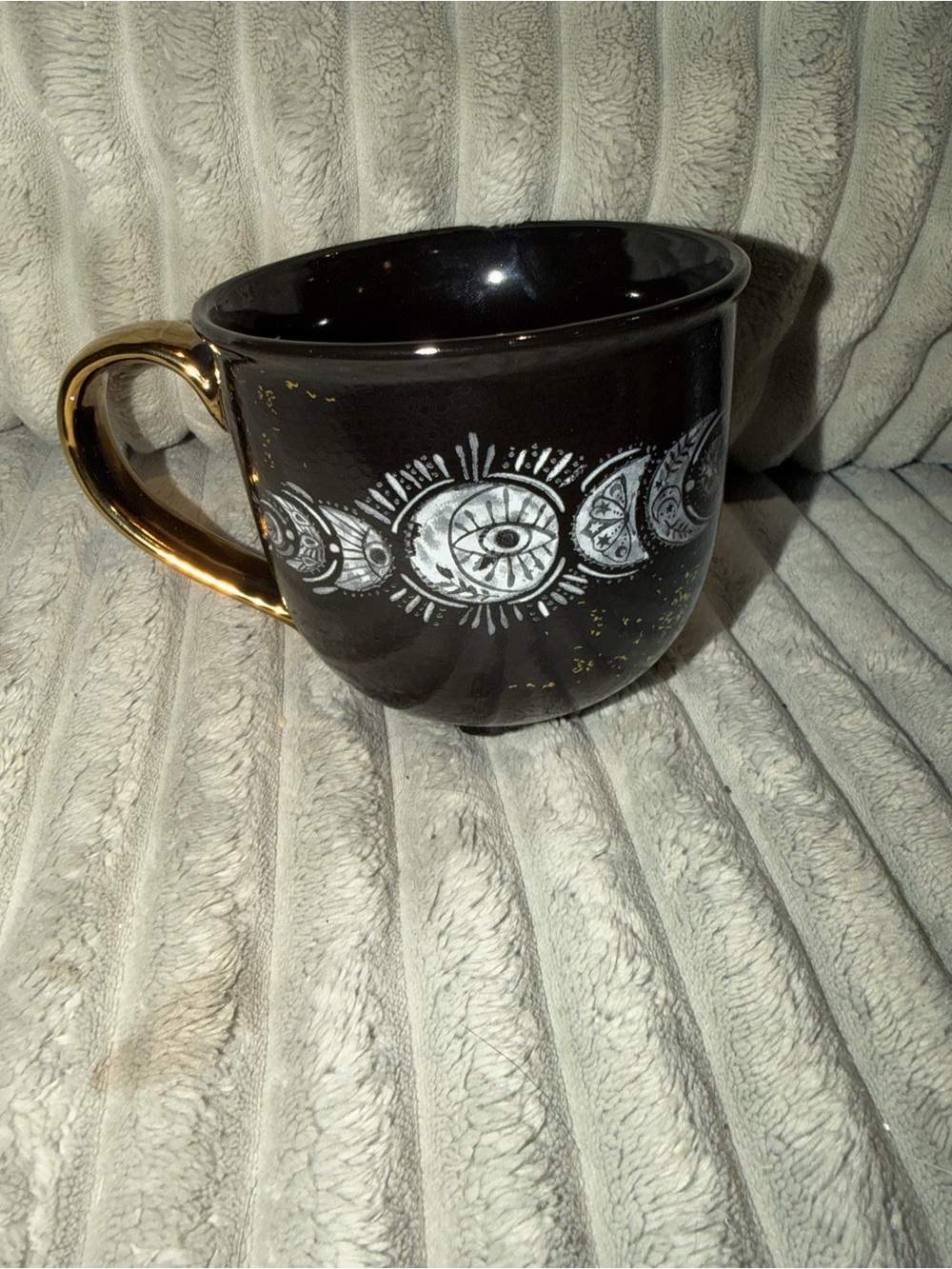 Black Ceramic Mug with Gold Handle and Eye Motif